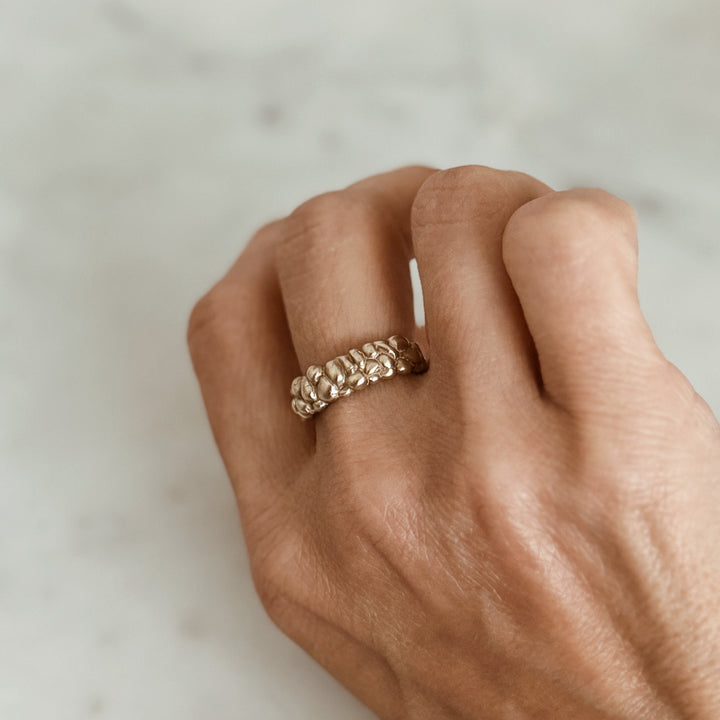Person Wears the MIMOSA Handcrafted Osage Orange Ring in Bronze