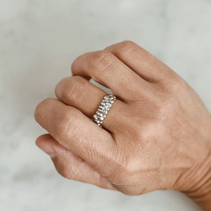 Person Wears the MIMOSA Handcrafted Osage Orange Ring in Sterling Silver