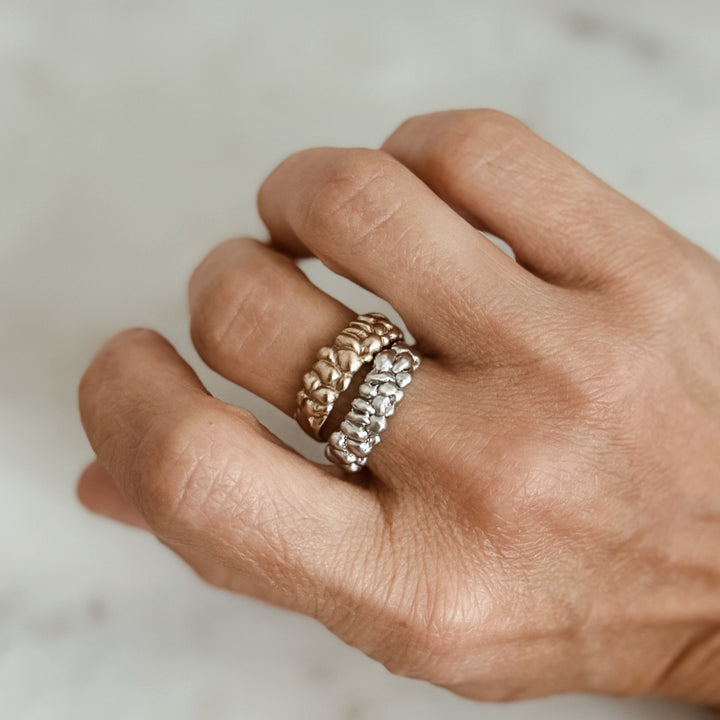 Person Wears the MIMOSA Handcrafted Osage Orange Rings in Bronze and Sterling Silver