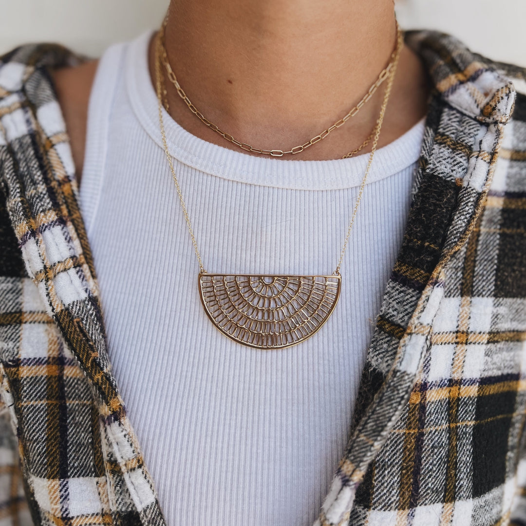 Woman wearing a bronze Shimmering Sun Necklace