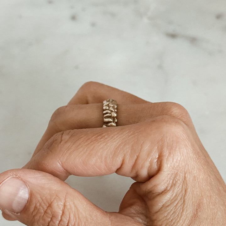 Person Wears the MIMOSA Handcrafted Osage Orange Ring in Bronze