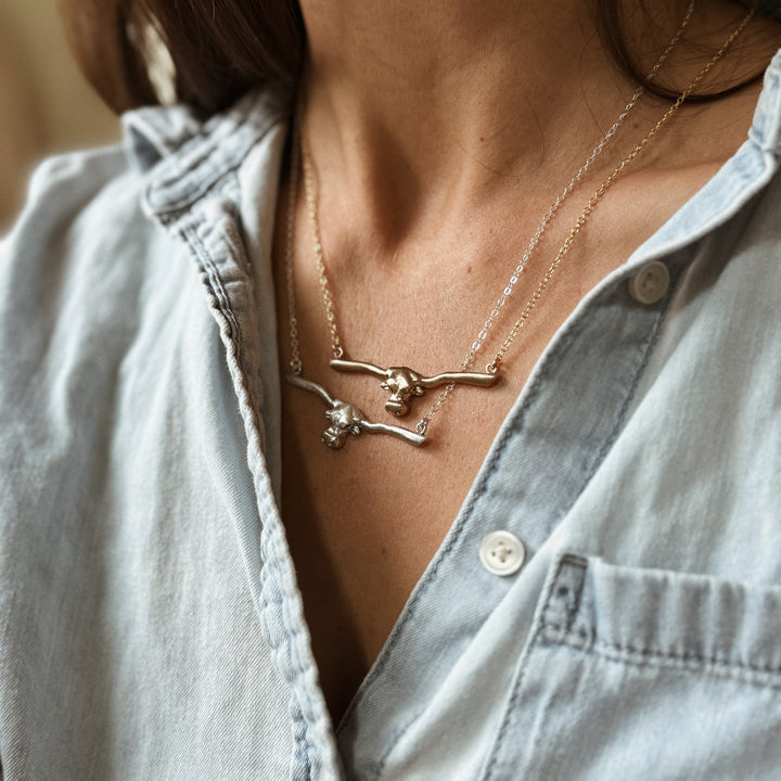 Woman Wears the MIMOSA Handcrafted Longhorn Bar Necklace in Bronze and Sterling Silver