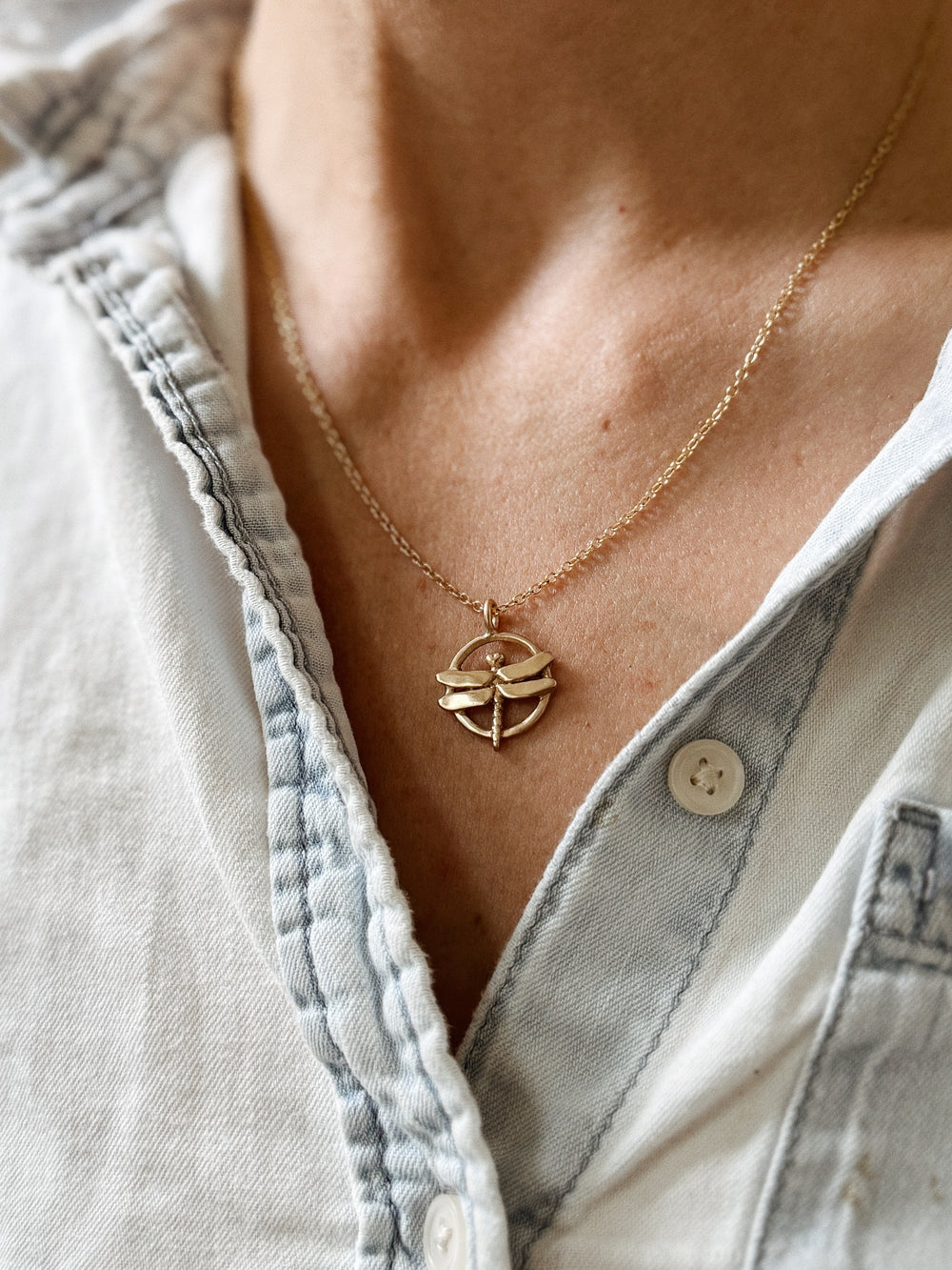 Person Wears MIMOSA Handcrafted's Dragonfly Pendant in Bronze