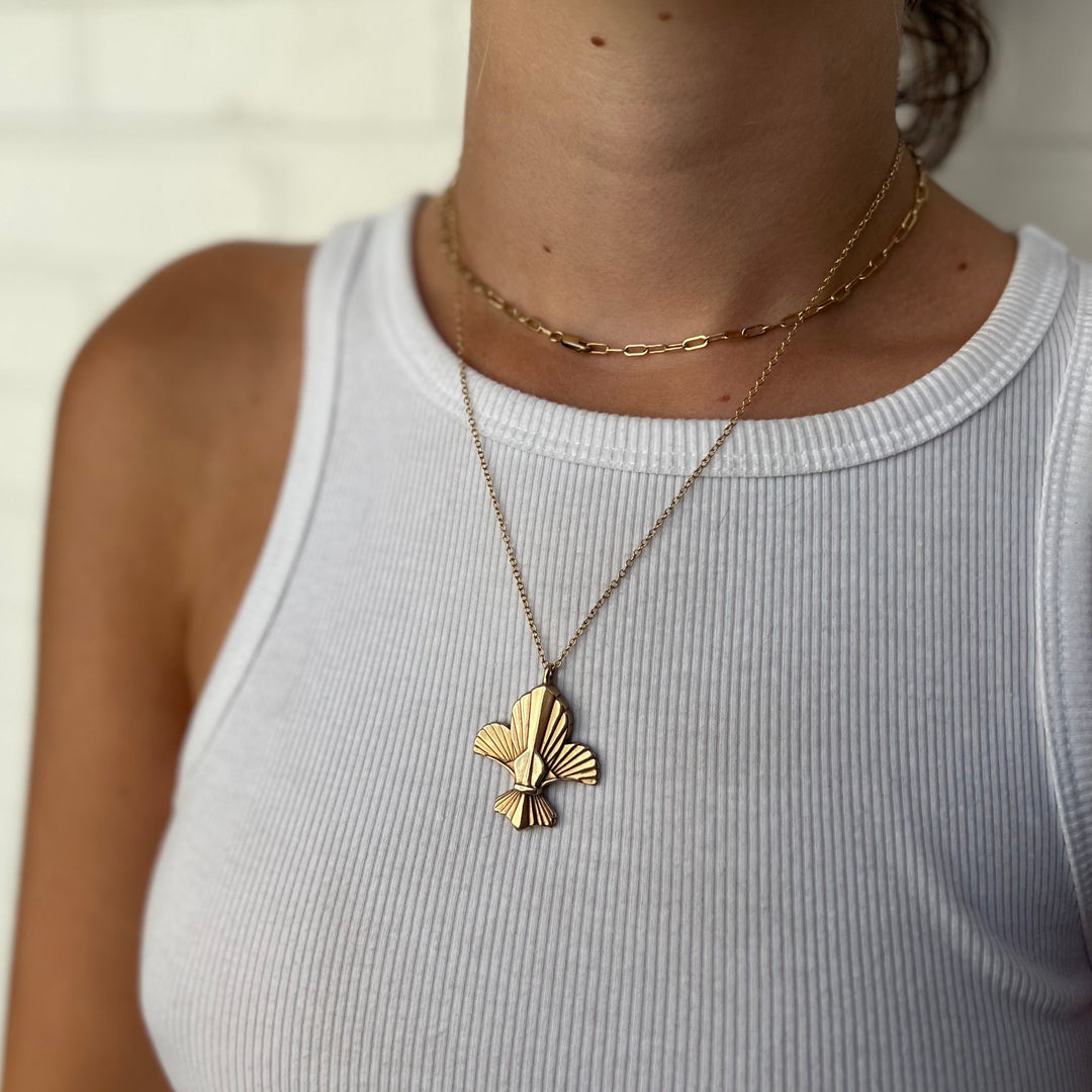 Woman Wearing Handcrafted Fleur De Lis Pendant Necklace