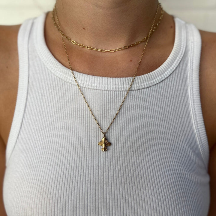 Woman Wearing Handcrafted Fleur De Lis Pendant Necklace