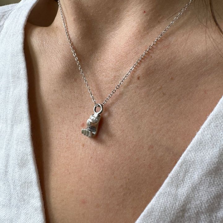 Woman Wears MIMOSA Handcrafted Heart Hand Necklace in Sterling Silver