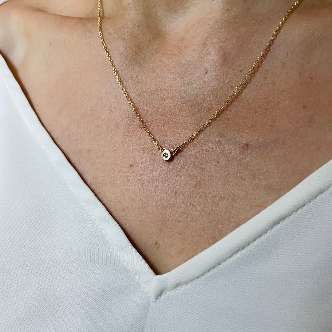 Woman Wearing Handmade Bronze Grace Pendant Necklace With Aquamarine Birthstone