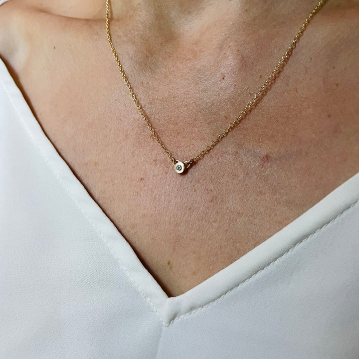 Woman Wearing Handmade Bronze Grace Pendant Necklace With Aquamarine Birthstone