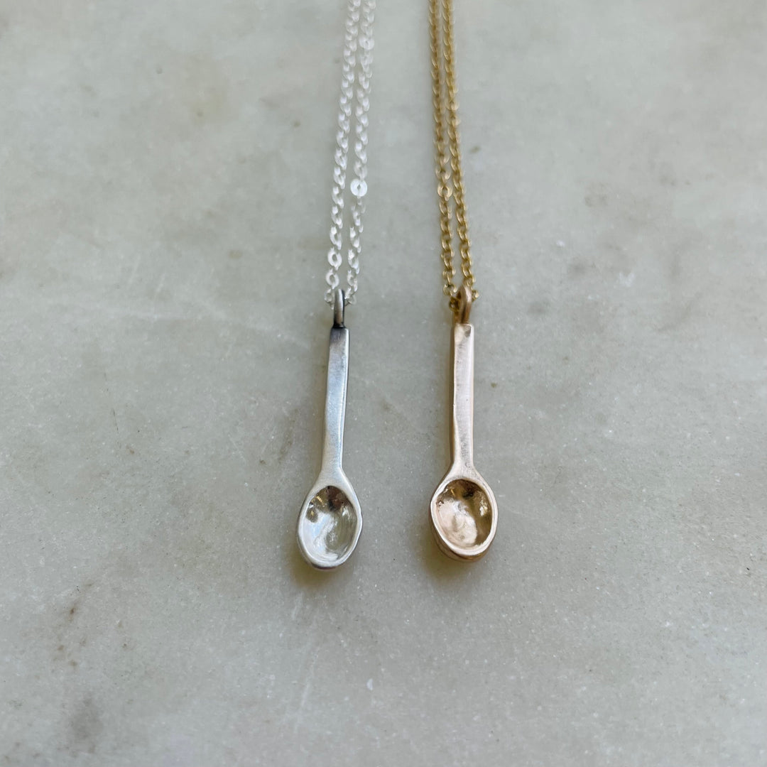 Small Handcrafted Silver And Bronze Spoon Pendants Shown Side By Side