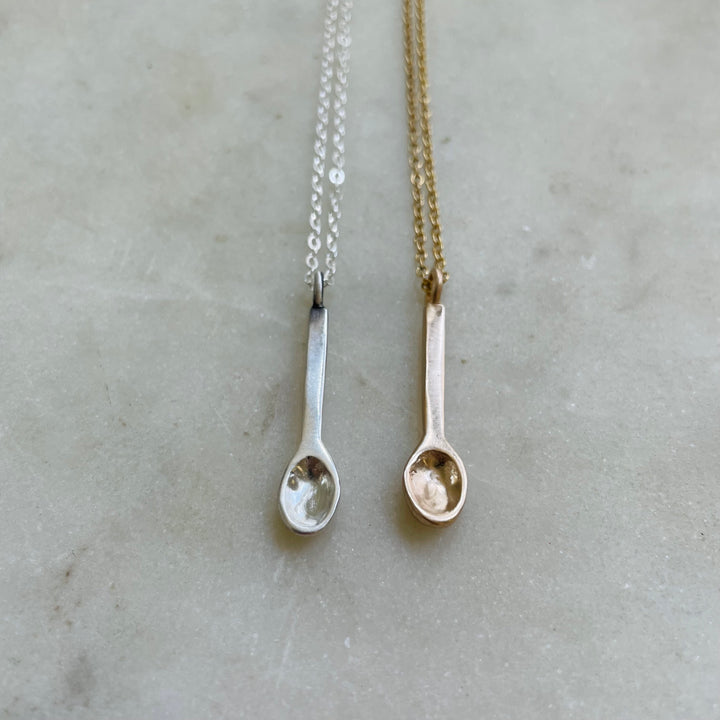 Small Handcrafted Silver And Bronze Spoon Pendants Shown Side By Side