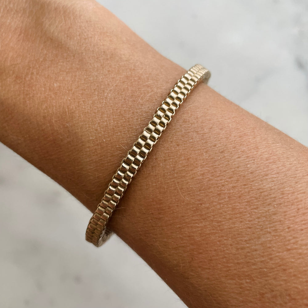 Woman Wears the MIMOSA Handcrafted Bronze Friendship Bracelet Named Ashley