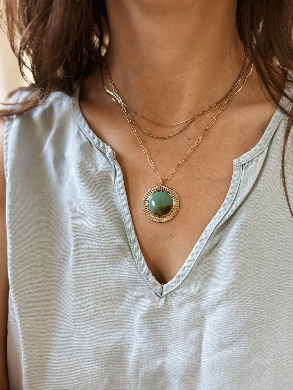 Woman Wears the MIMOSA Handcrafted Sunburst Pendant with Turquoise