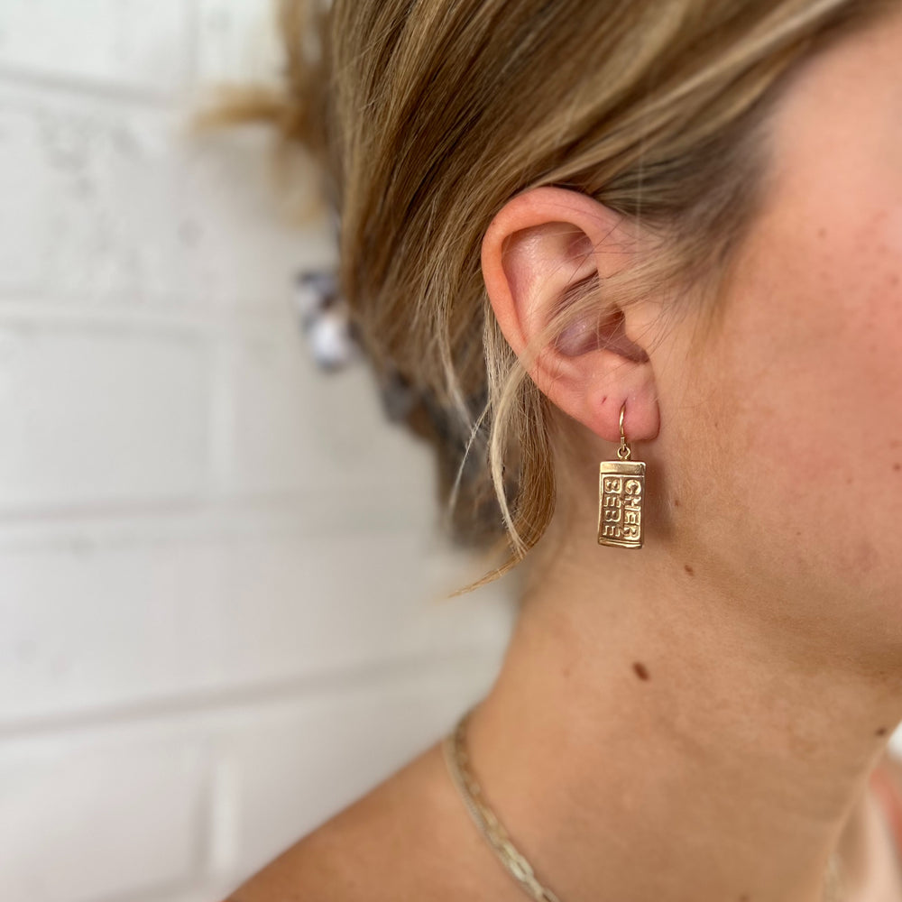 Woman Wears MIMOSA Handcrafted Cher Bebe Earrings in Bronze.