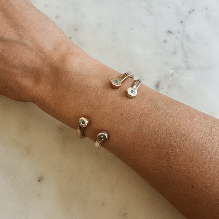Woman Wears the MIMOSA Handcrafted Duo Turquoise Bracelet in Sterling Silver and Bronze