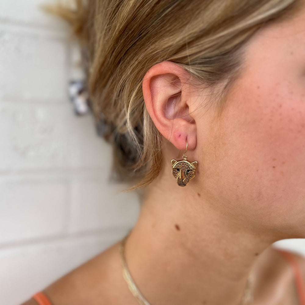Woman Wears MIMOSA Handcrafted Jaguar Earrings in Bronze.