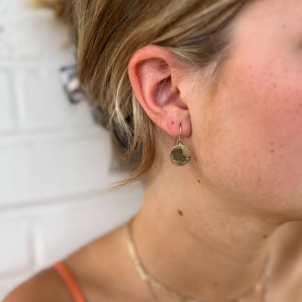 Woman Wears MIMOSA Handcrafted Louisiana Burst Earrings in Bronze.