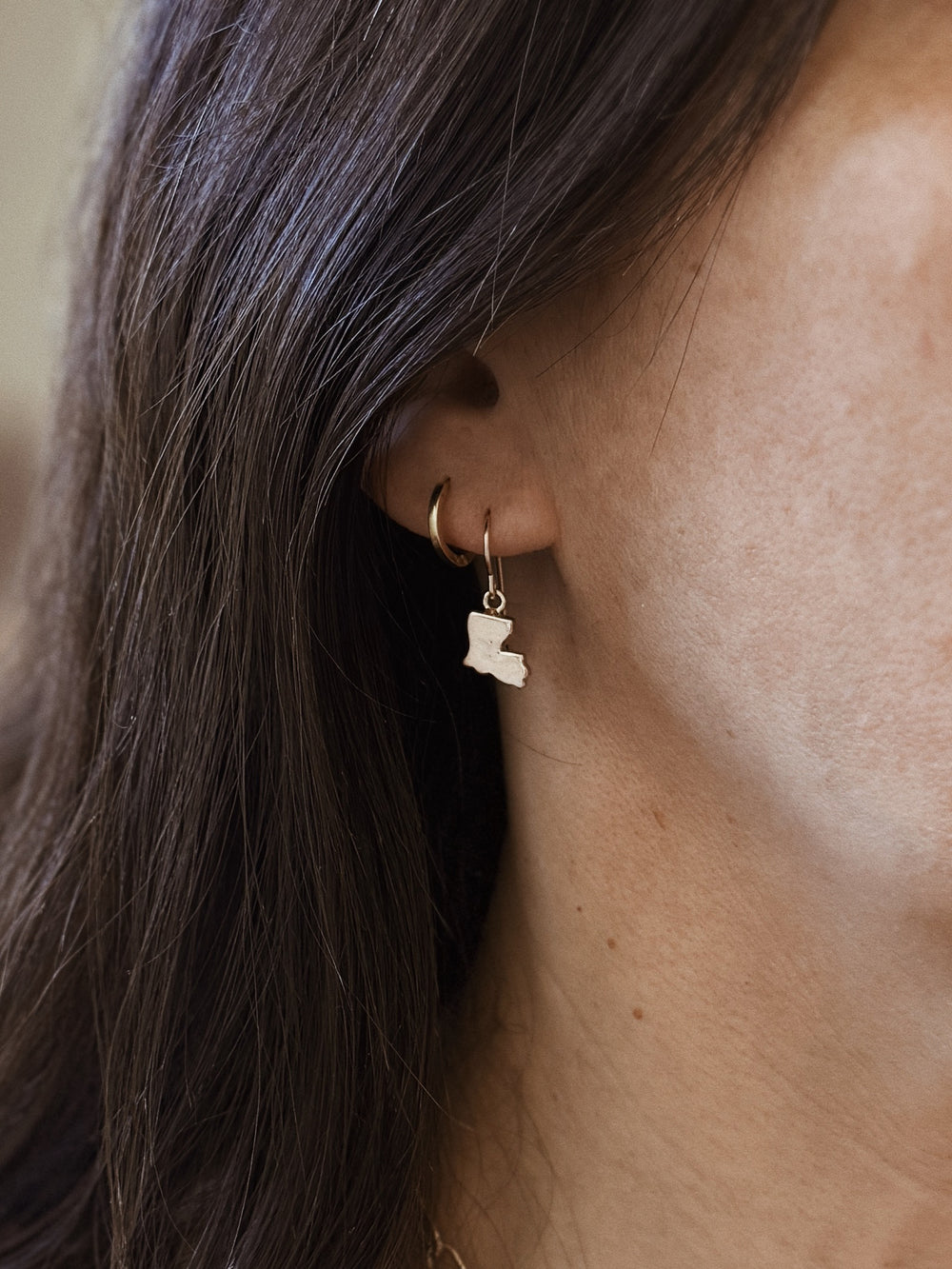 Woman Wears the MIMOSA Handcrafted Bronze Louisiana State Earrings