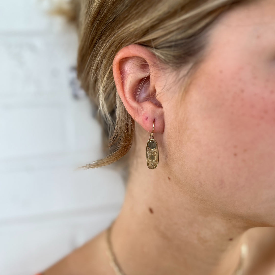 Woman Wears MIMOSA Handcrafted Louisiana Wild Earrings in Bronze.