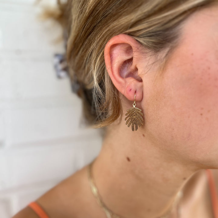 Woman Wears MIMOSA Handcrafted Small Mimosa Leaf Earrings in Bronze.