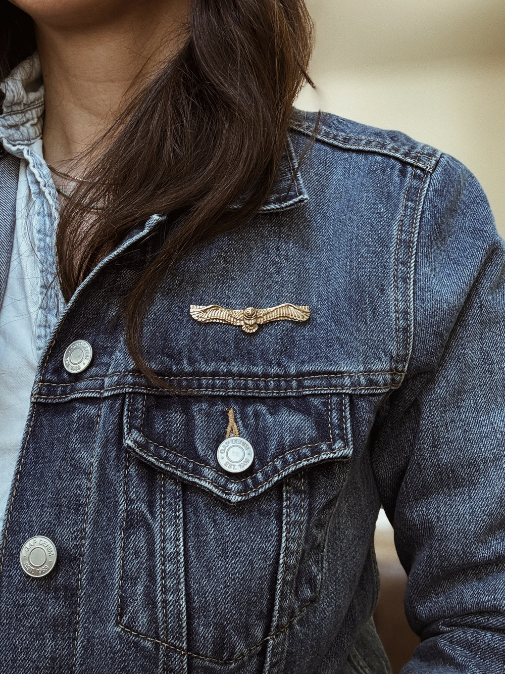 Woman Wears the MIMOSA Handcrafted Owl Pin on a Denim Jacket