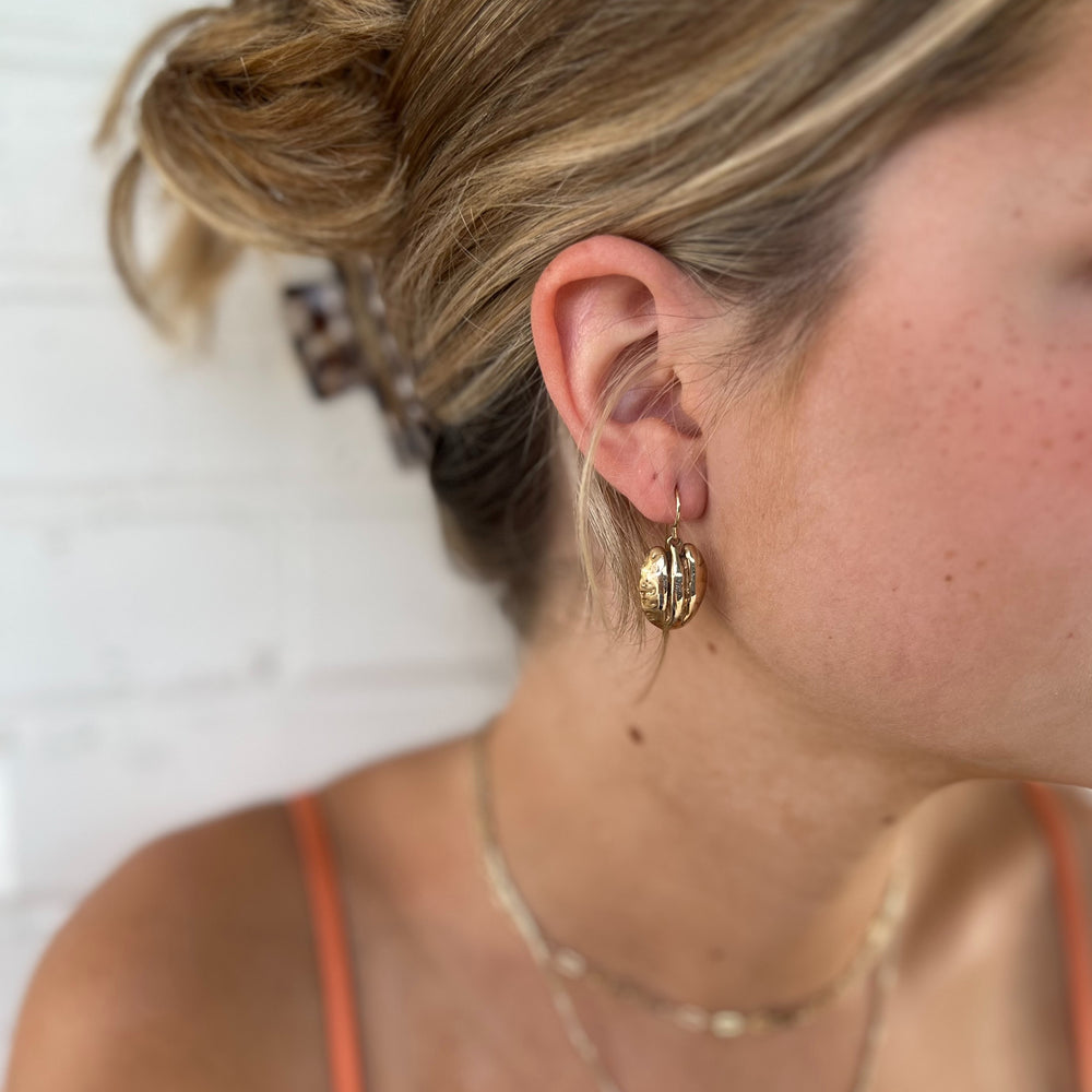 Woman Wears MIMOSA Handcrafted Pecan Earrings in Bronze.