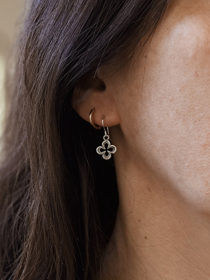 Woman Wears the MIMOSA Handcrafted Small Sterling Silver Quatrefoil Earrings
