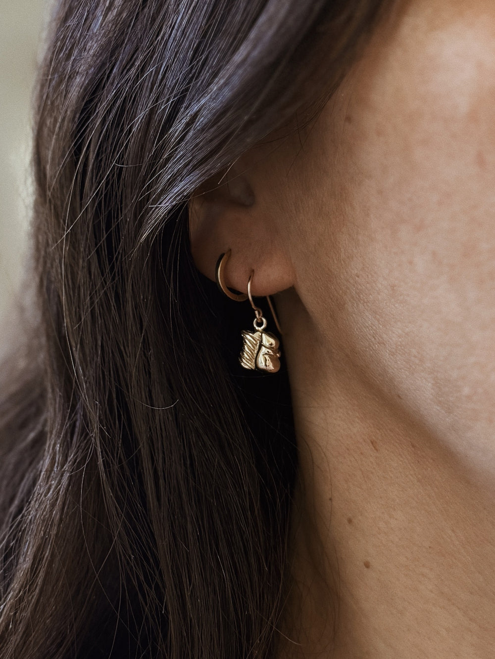 Woman Wears the MIMOSA Handcrafted Bronze Squirrel Earrings