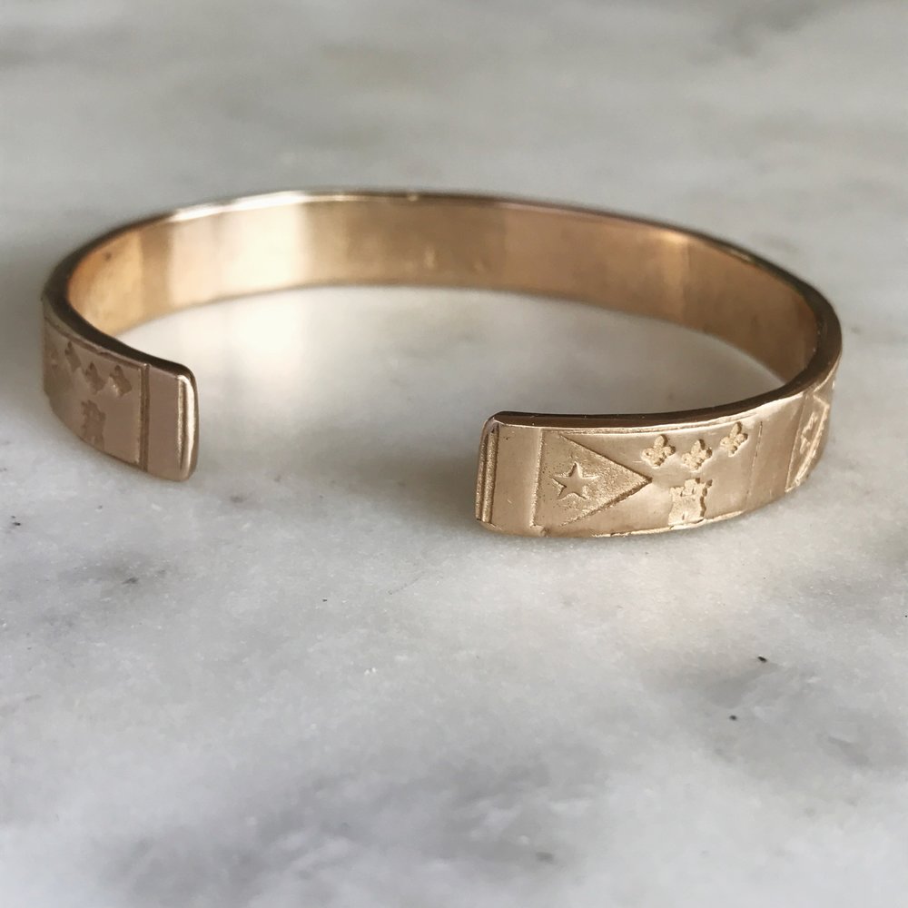 Underside of Handmade Bronze Bracelet Stamped with Acadian Flags