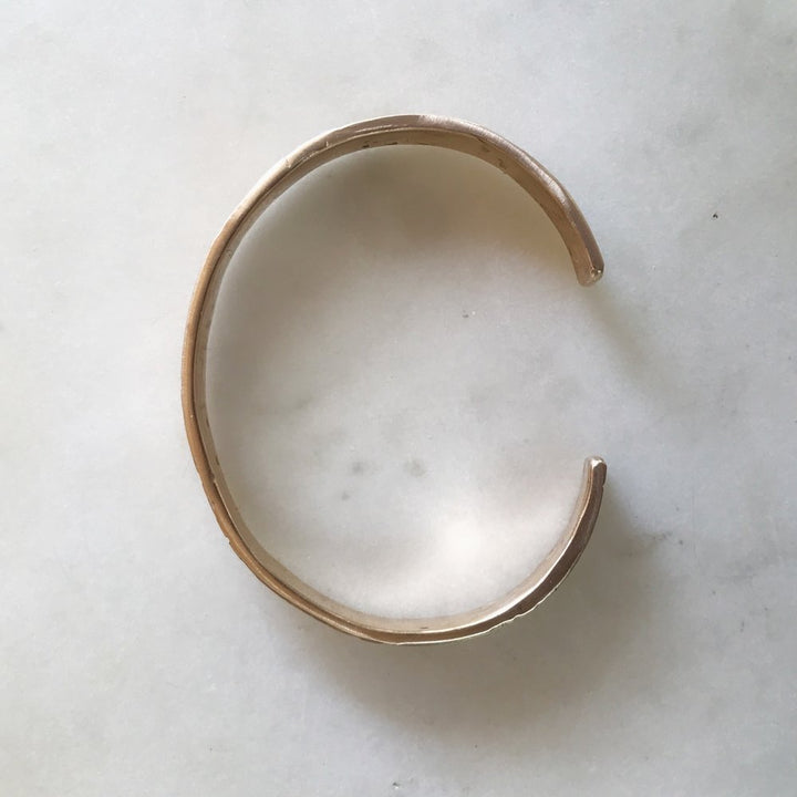 Side View of Handmade Bronze Bracelet Stamped with Acadian Flags