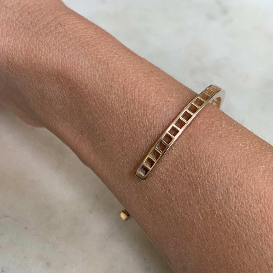 Woman Wearing Handmade Bronze Single Row Grid Cuff Bracelet