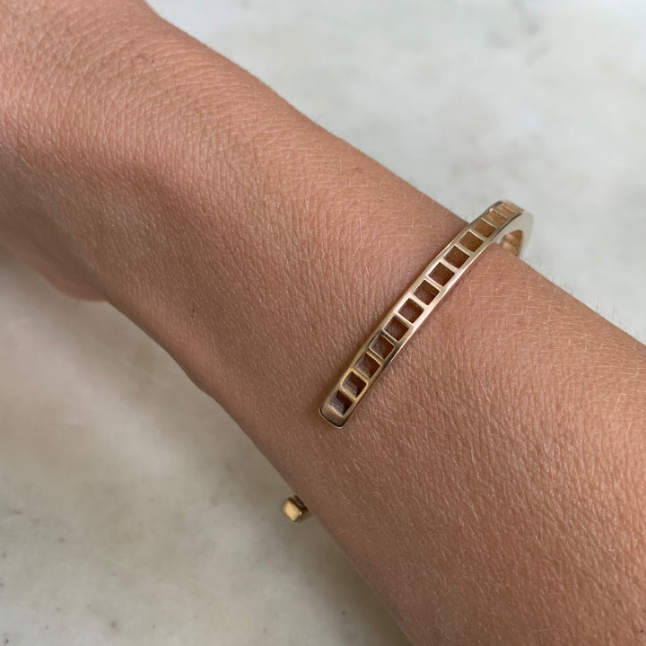 Woman Wearing Handmade Bronze Single Row Grid Cuff Bracelet