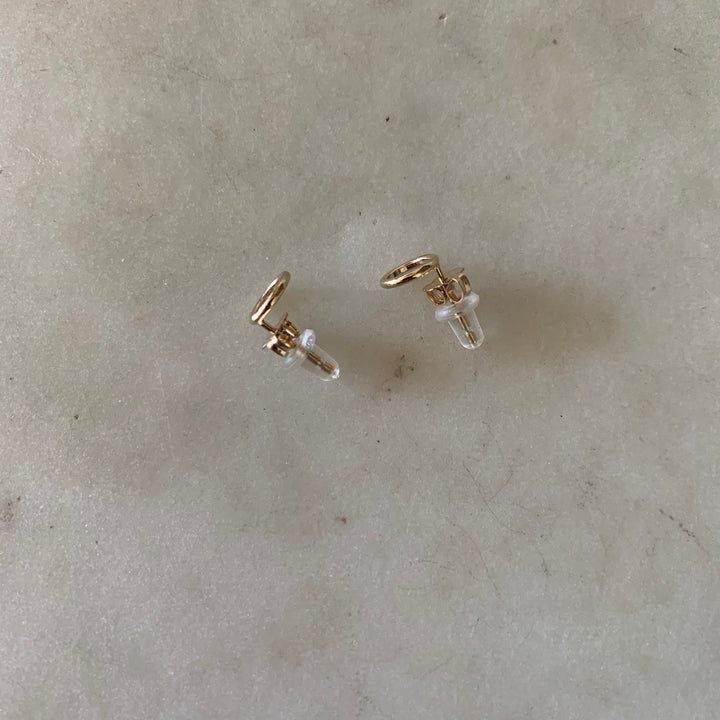 Gold-filled open circle stud earrings with ear nuts and rubber backs