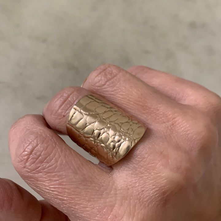 Woman Wearing Handmade Bronze Alligator Skin Ring on middle finger