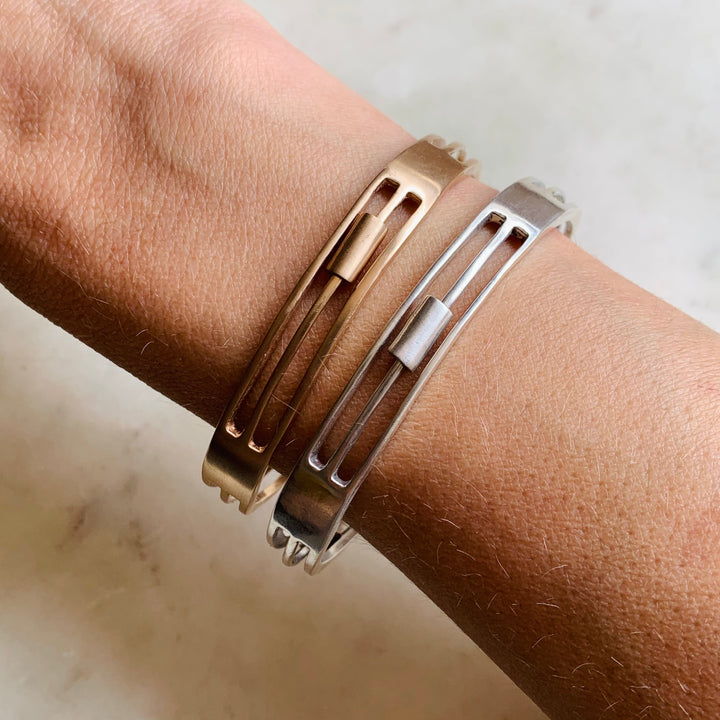 Woman Wearing Handmade Bronze and Sterling Silver Daydreamer Cuff Bracelets with moving parts