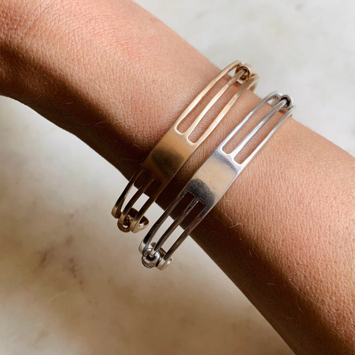 Woman Wearing Handmade Bronze and Sterling Silver Daydreamer Cuff Bracelets with moving parts