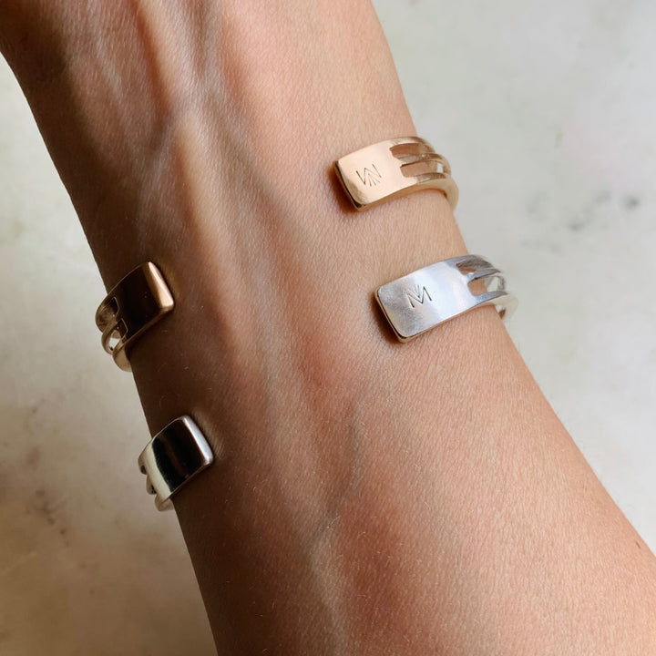Woman Wearing Handmade Bronze and Sterling Silver Daydreamer Cuff Bracelets with moving parts