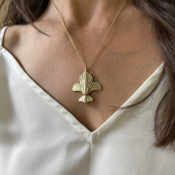 Woman Wearing Handcrafted Fleur De Lis Pendant Necklace