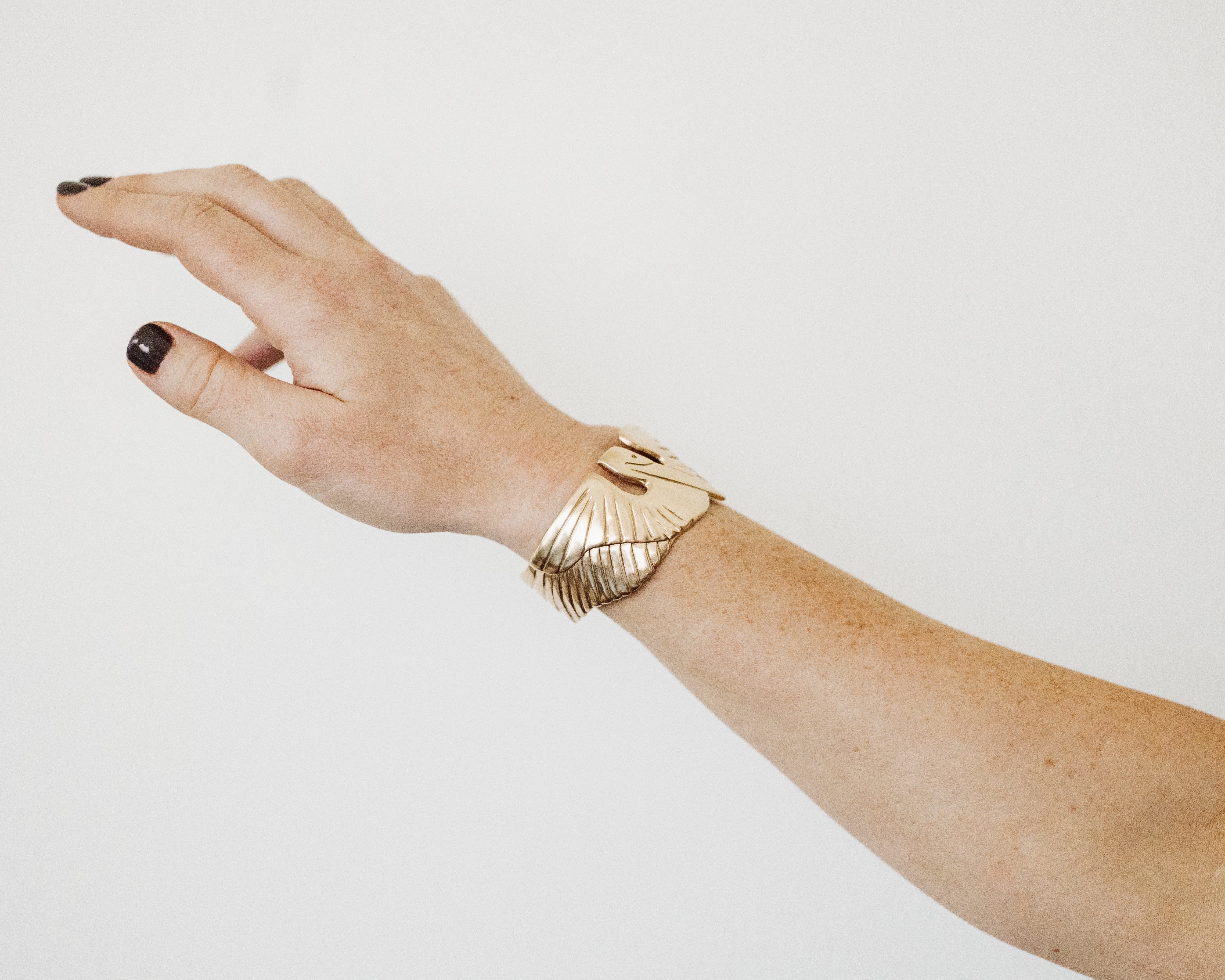 A Woman Wears MIMOSA's Bronze Pelican Bracelet