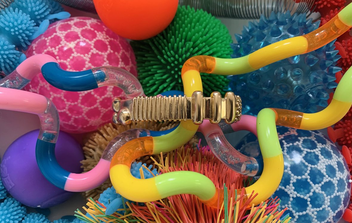 MIMOSA Handcrafted's Sensory Jewelry, The Tactile Cuff, Is Nestled Into A Variety Of Sensory Toys