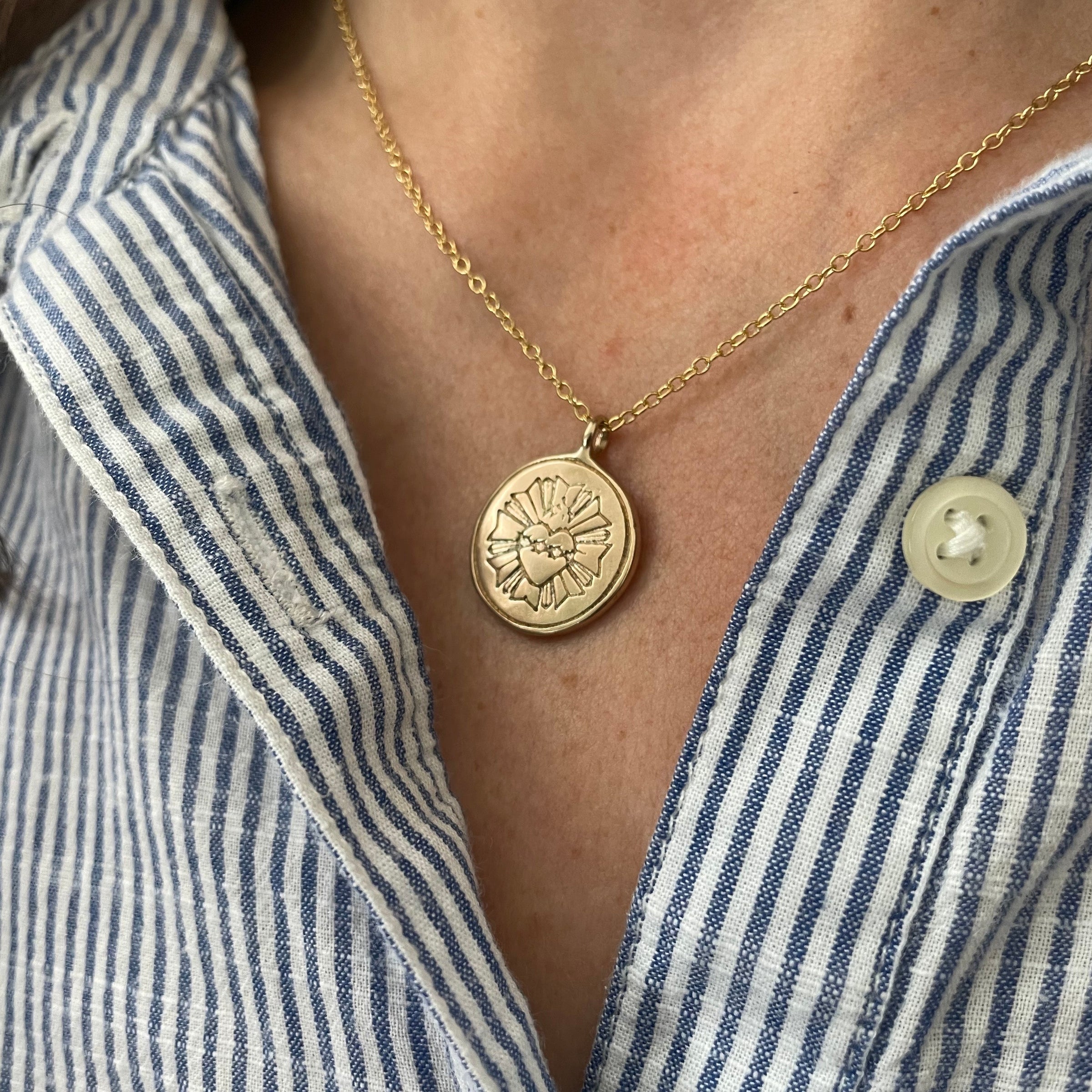 Woman Wears MIMOSA Handcrafted's Bronze Sacred Heart Necklace