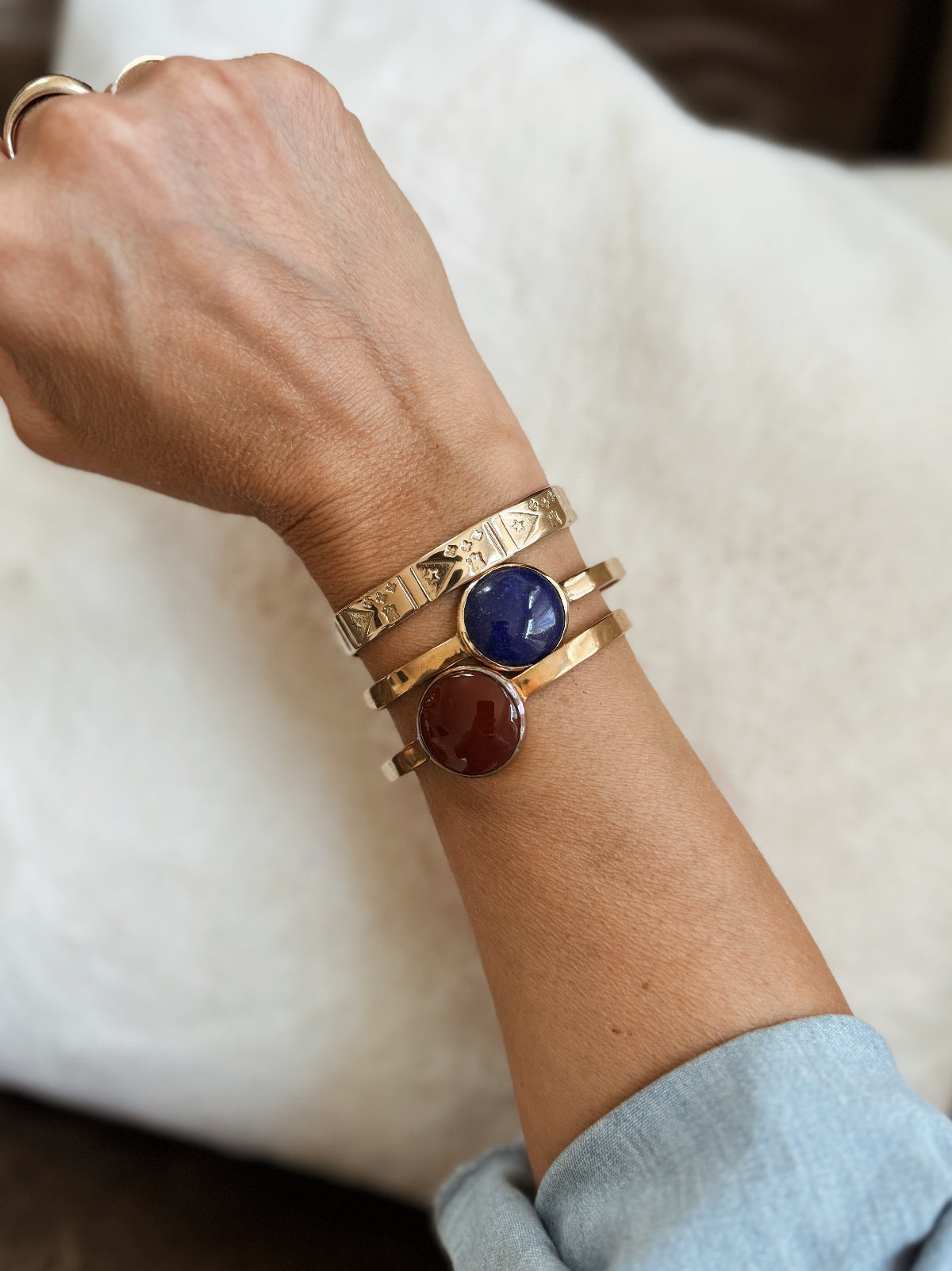 Woman Wears the Acadian Flag Cuff with Two Greta Cuffs