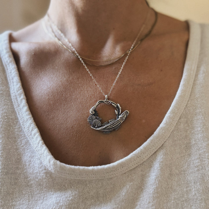 Woman wears Plein Wild Swamp-Inspired Pendant from MIMOSA Handcrafted