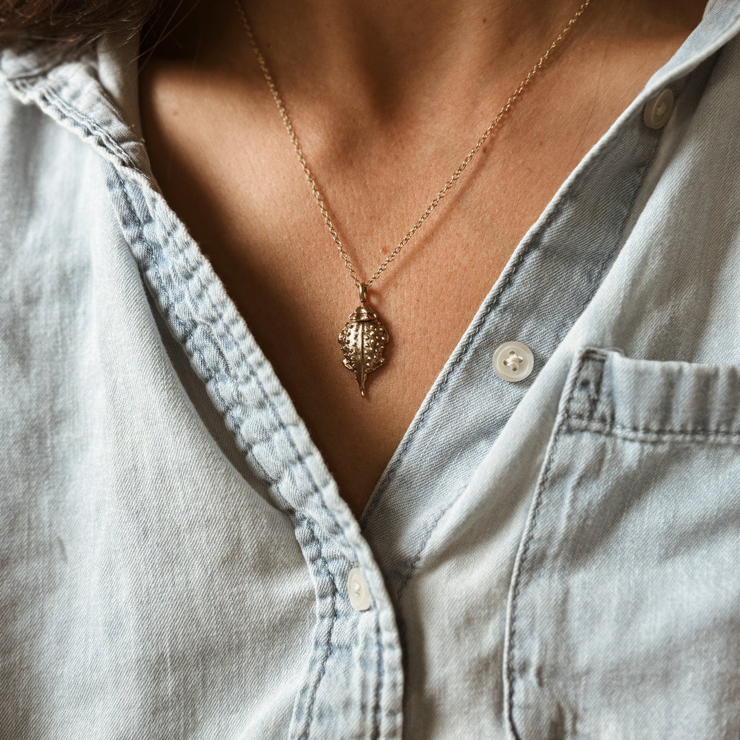 Person Wears the MIMOSA Handcrafted Horned Toad Pendant in Bronze