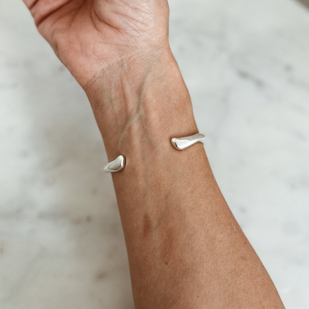 Person Wears the MIMOSA Handcrafted Longhorn Cuff in Sterling Silver