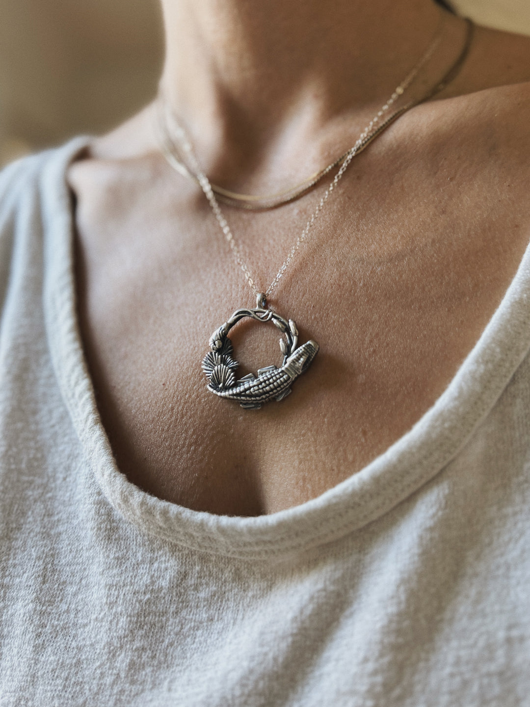 Woman wears Plein Wild Swamp-Inspired Pendant from MIMOSA Handcrafted