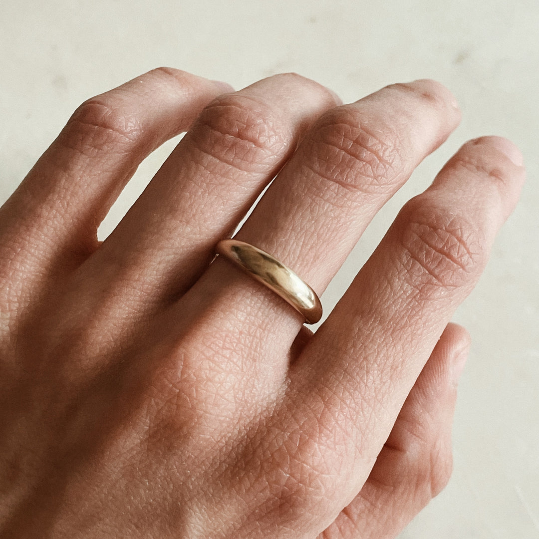 Person Wears a Dainty Dome Ring in 14K Gold