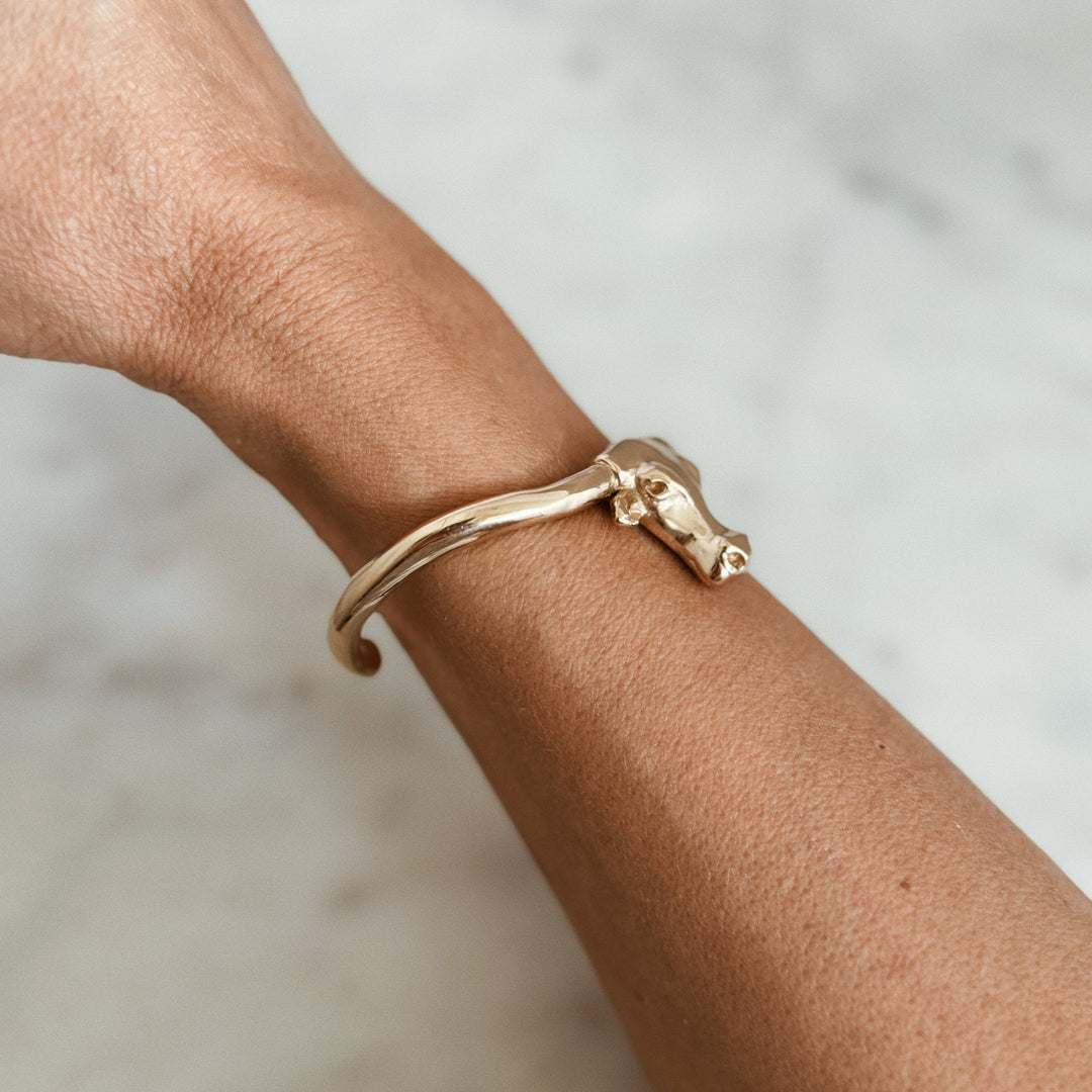 Person Wears the MIMOSA Handcrafted Longhorn Cuff in Bronze