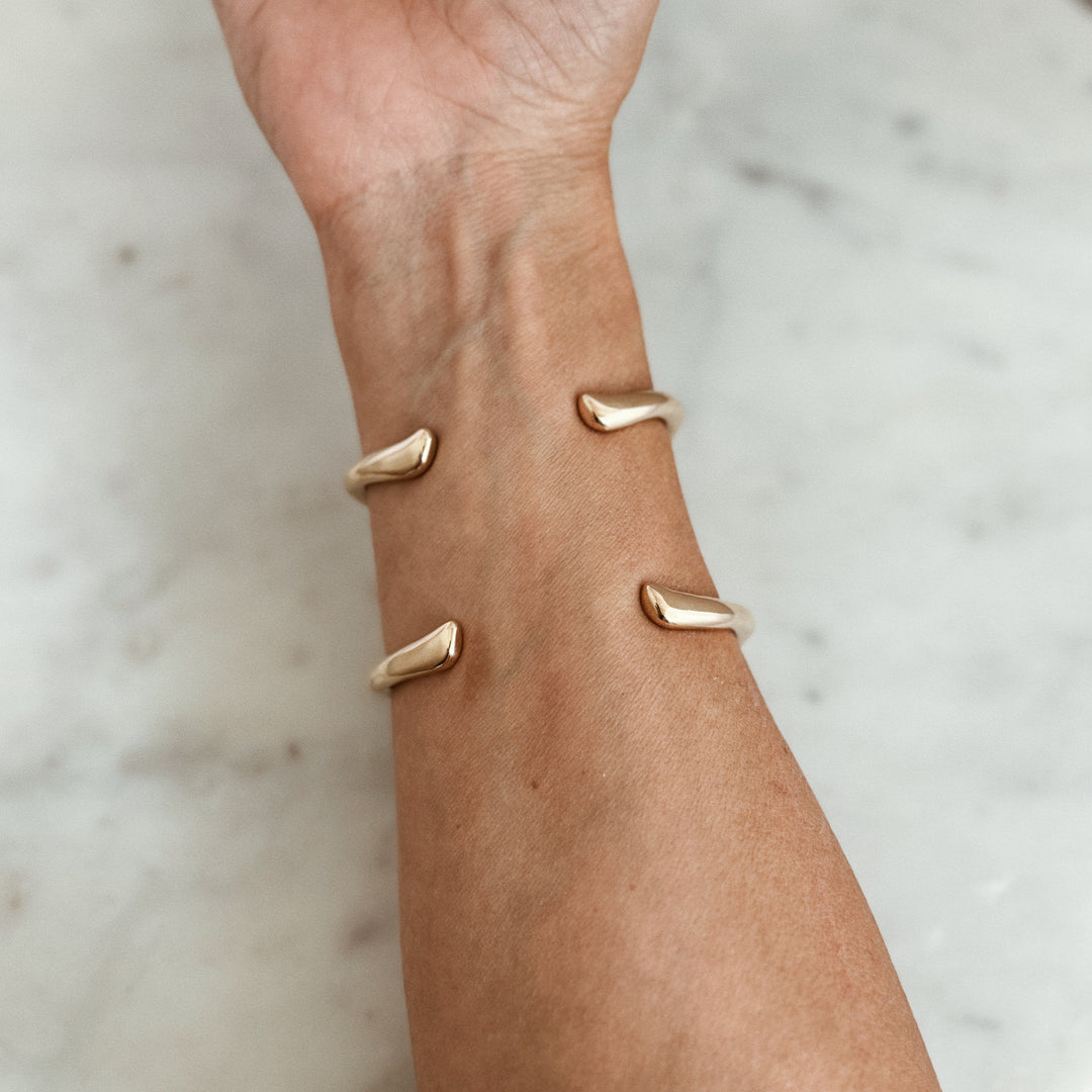 Person Wears the MIMOSA Handcrafted Longhorn Cuff in Bronze