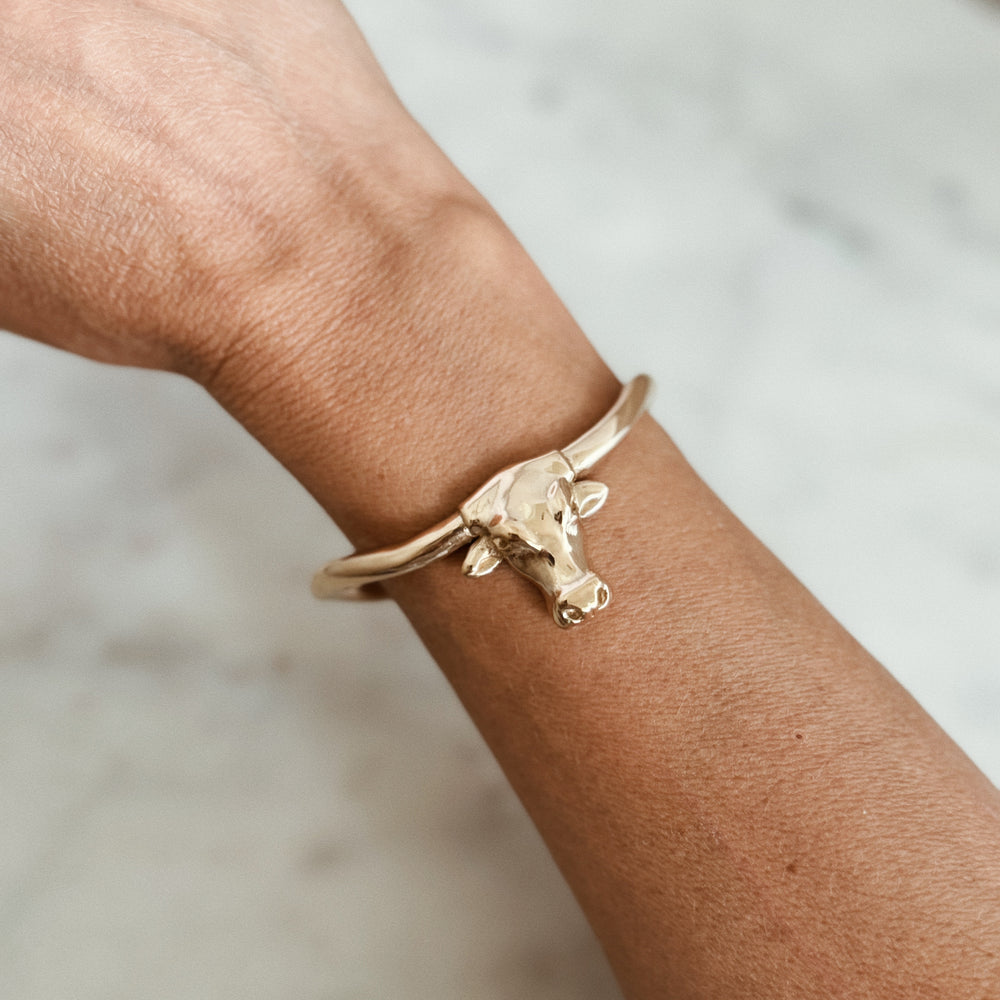 Person Wears the MIMOSA Handcrafted Longhorn Cuff in Bronze