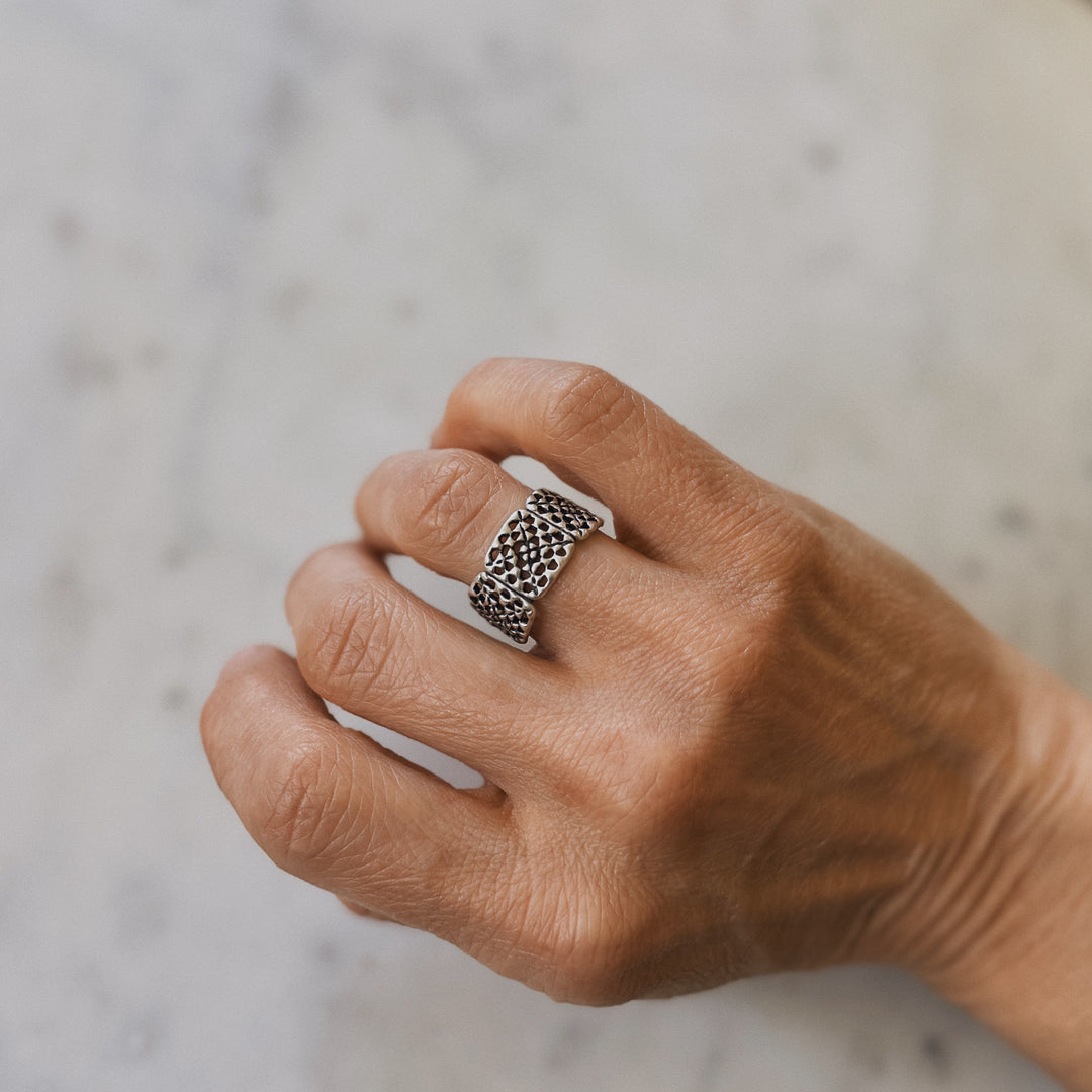 Person wears a handmade granny square ring in sterling silver by MIMOSA Handcrafted
